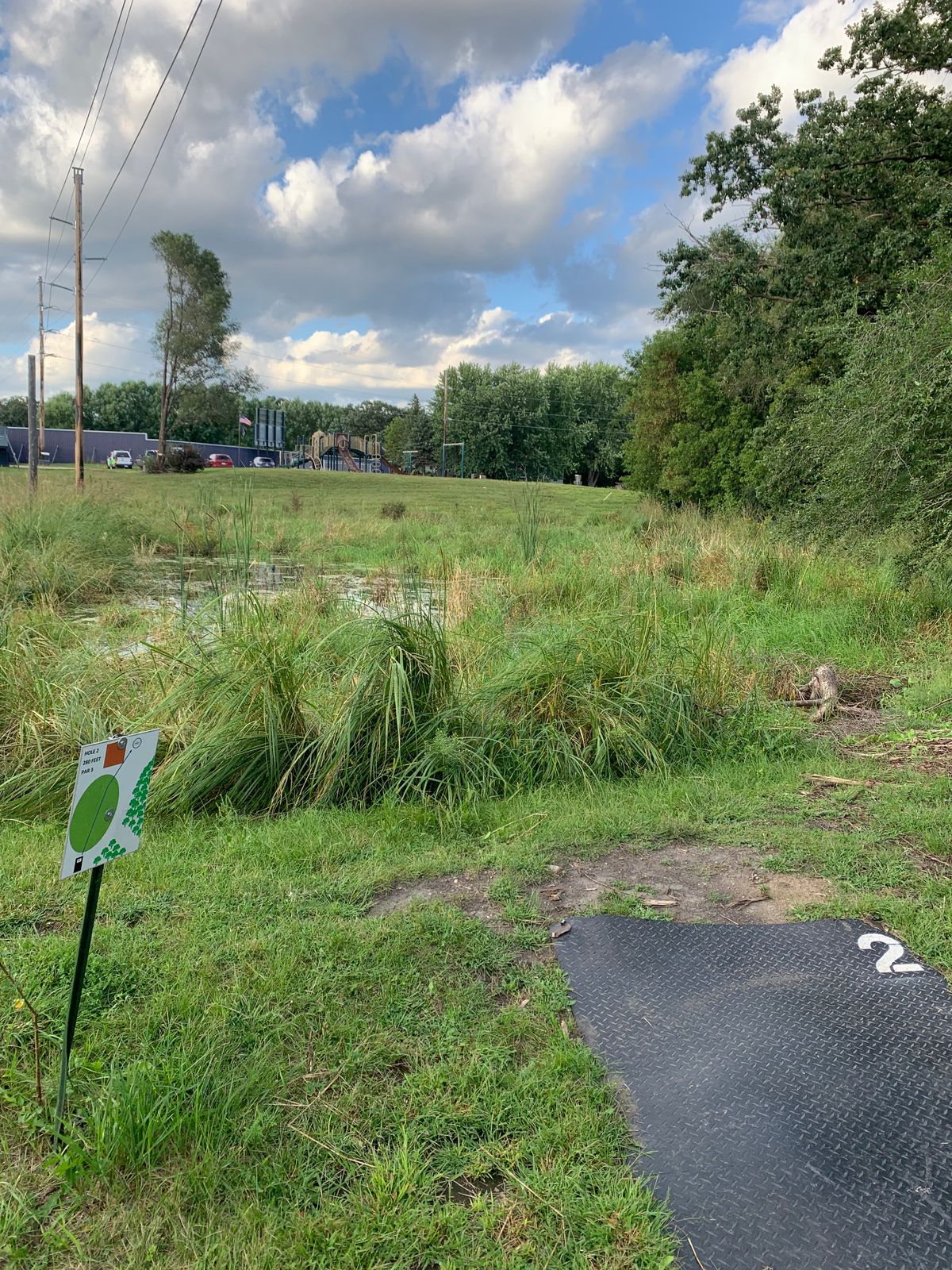 Hole 2 tee pad. Throw over the small pond. August 2024.