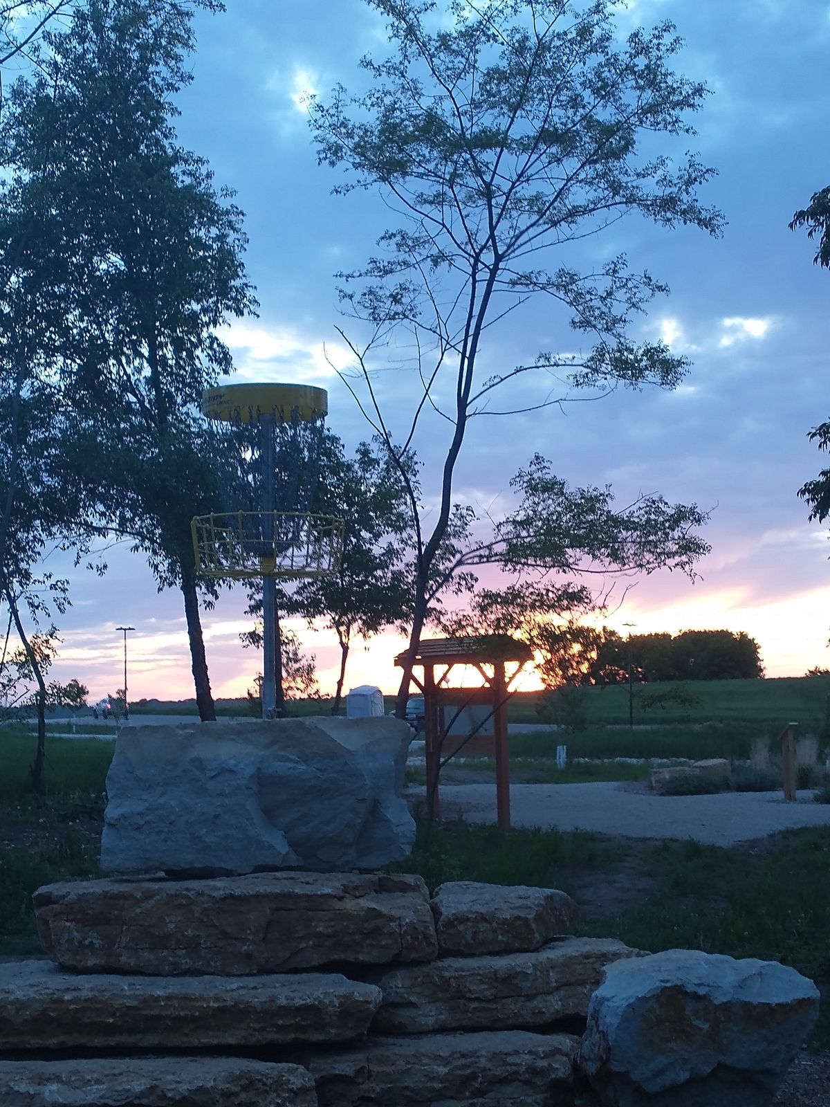Hole 18 with a pretty sunset behind it.