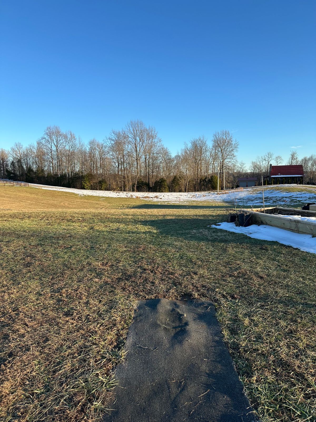 Hole 7 tee pad, road and beyond is OB.