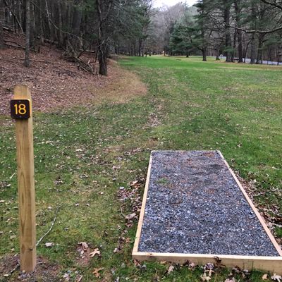 Tee Box 18 - long flat open drive, basket sits uphill with small dogleg left