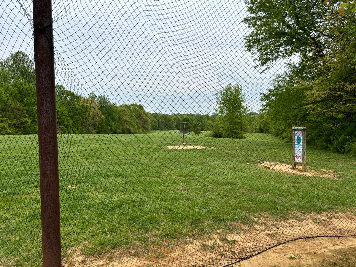 The practice basket and driving practice net next to the first tee.