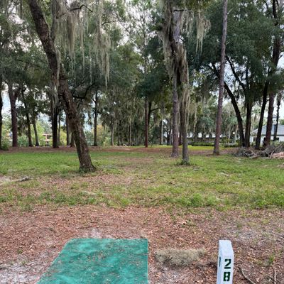 Surrounded by or beyond concrete is OB.  Surrounded by water in pond is OB.
