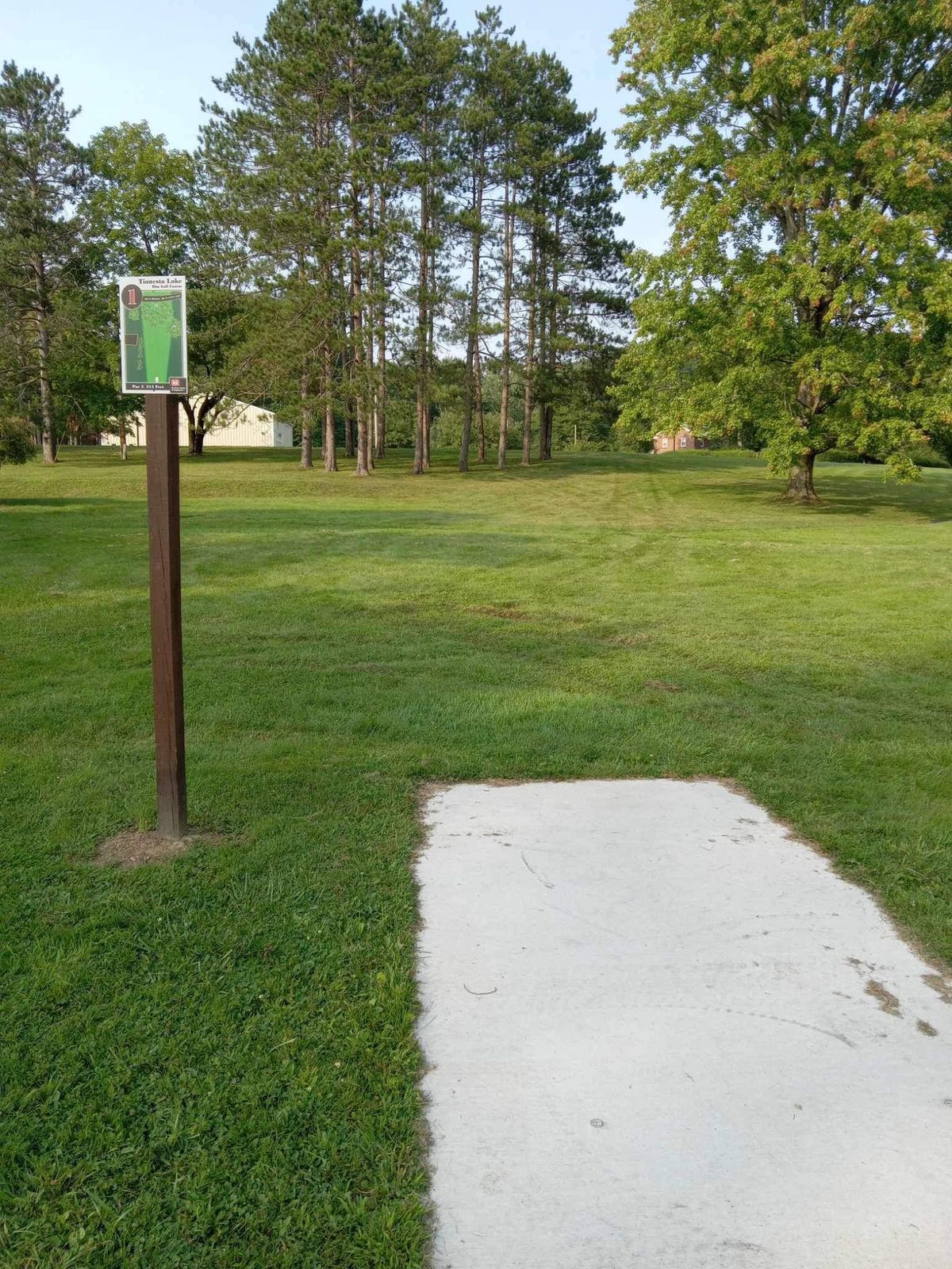 Hole 1 with new concrete tee pad and sign.