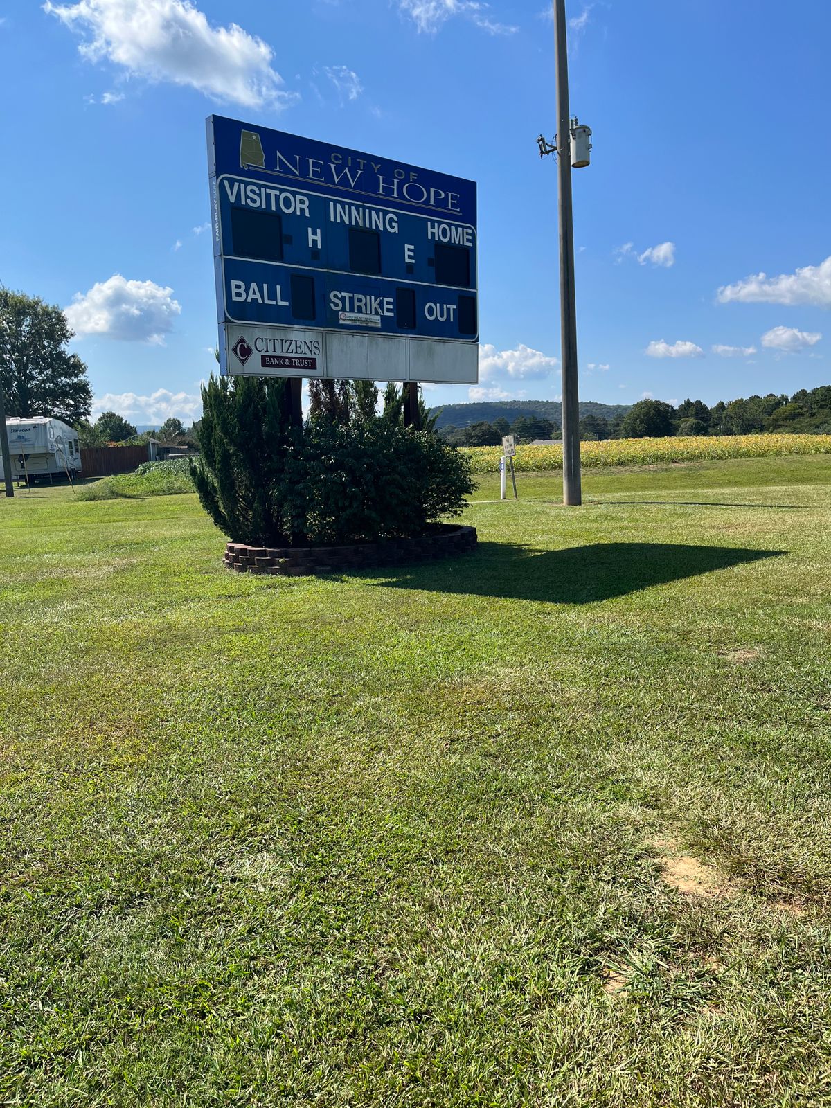 The tee box for 14 is beside the scoreboard behind left field.