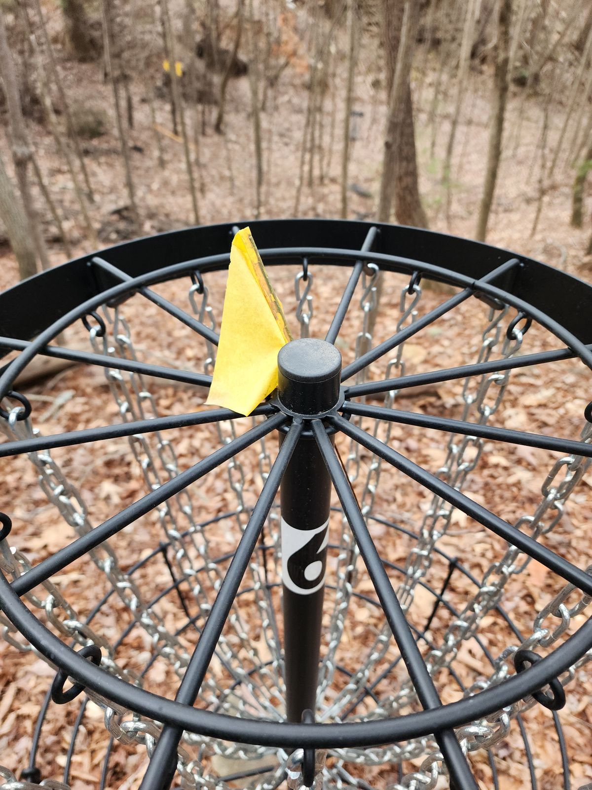 Black baskets hard to identify it heavily wooded area. The little yellow flags on top do not help visibility at all