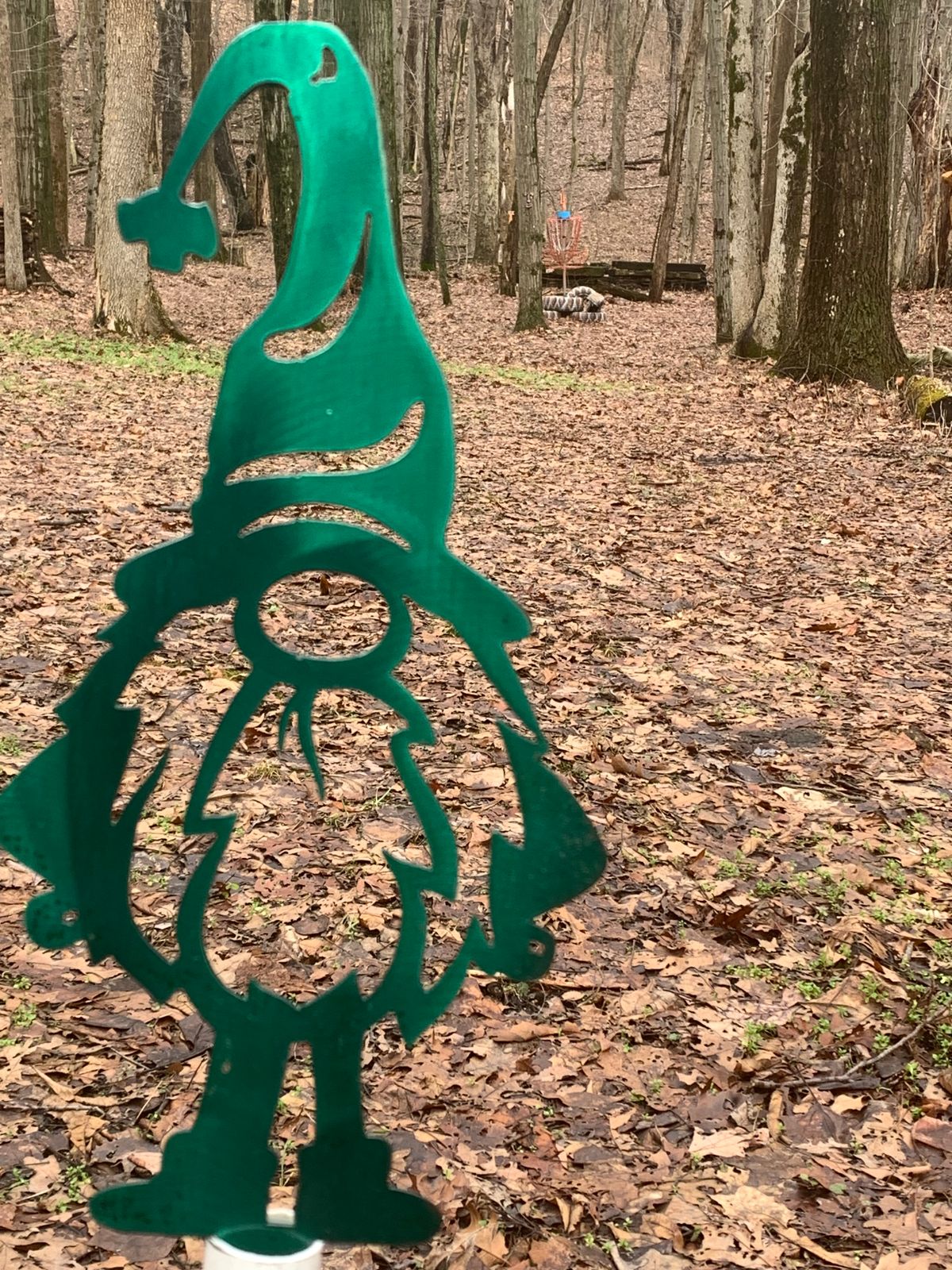 Gnomes on black and white posts are 100 foot markers to the basket.