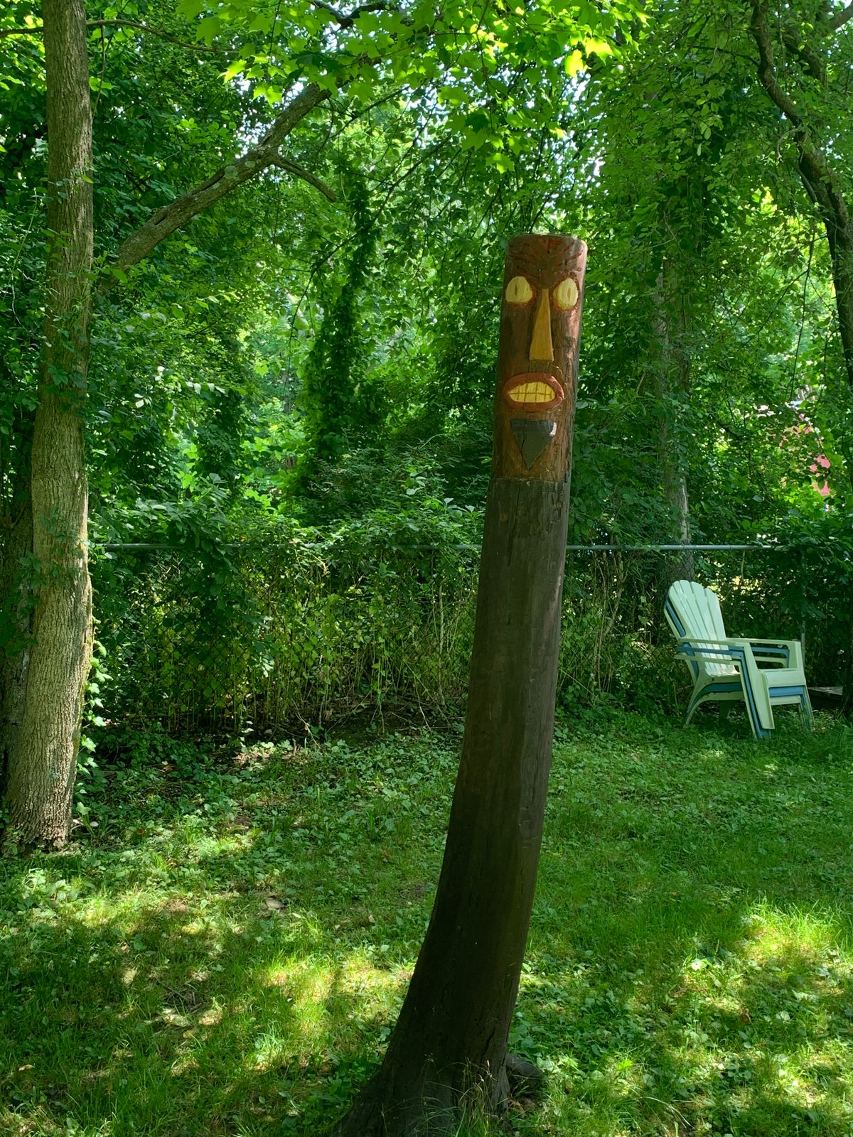 Carved Tiki near the shed basket