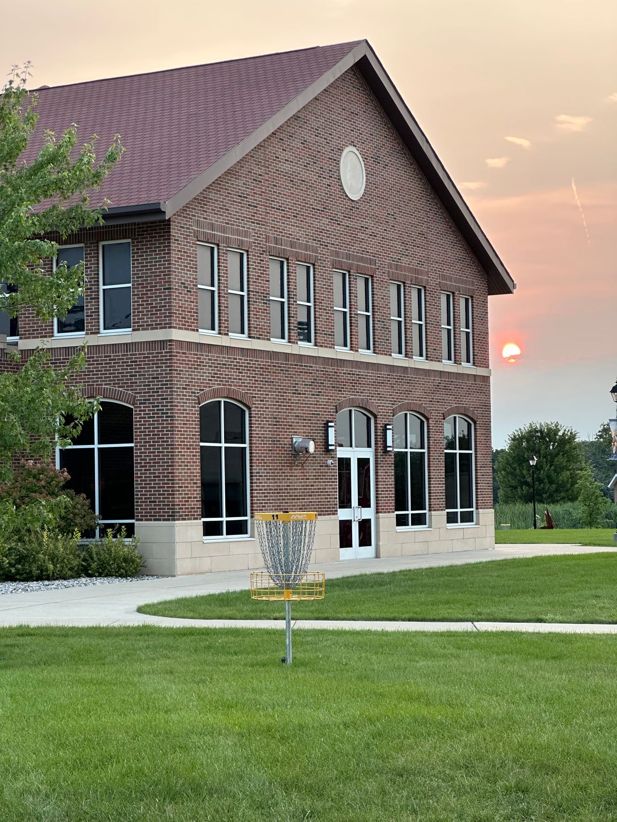 Hole 11 basket. Tee box is perpendicular to the left, up a hill.