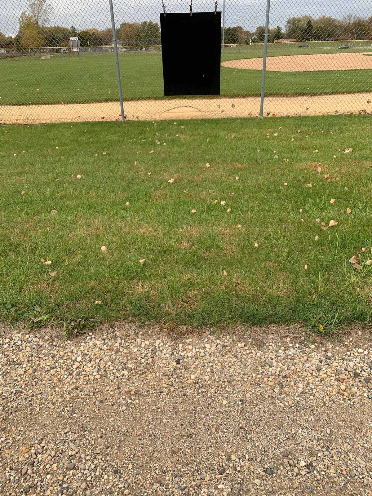 Hole 5 long tee. Sign reference to the right on fence