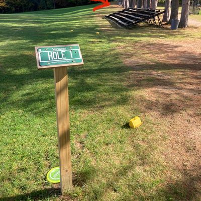 Hole 1 tee (red arrows point to basket)
