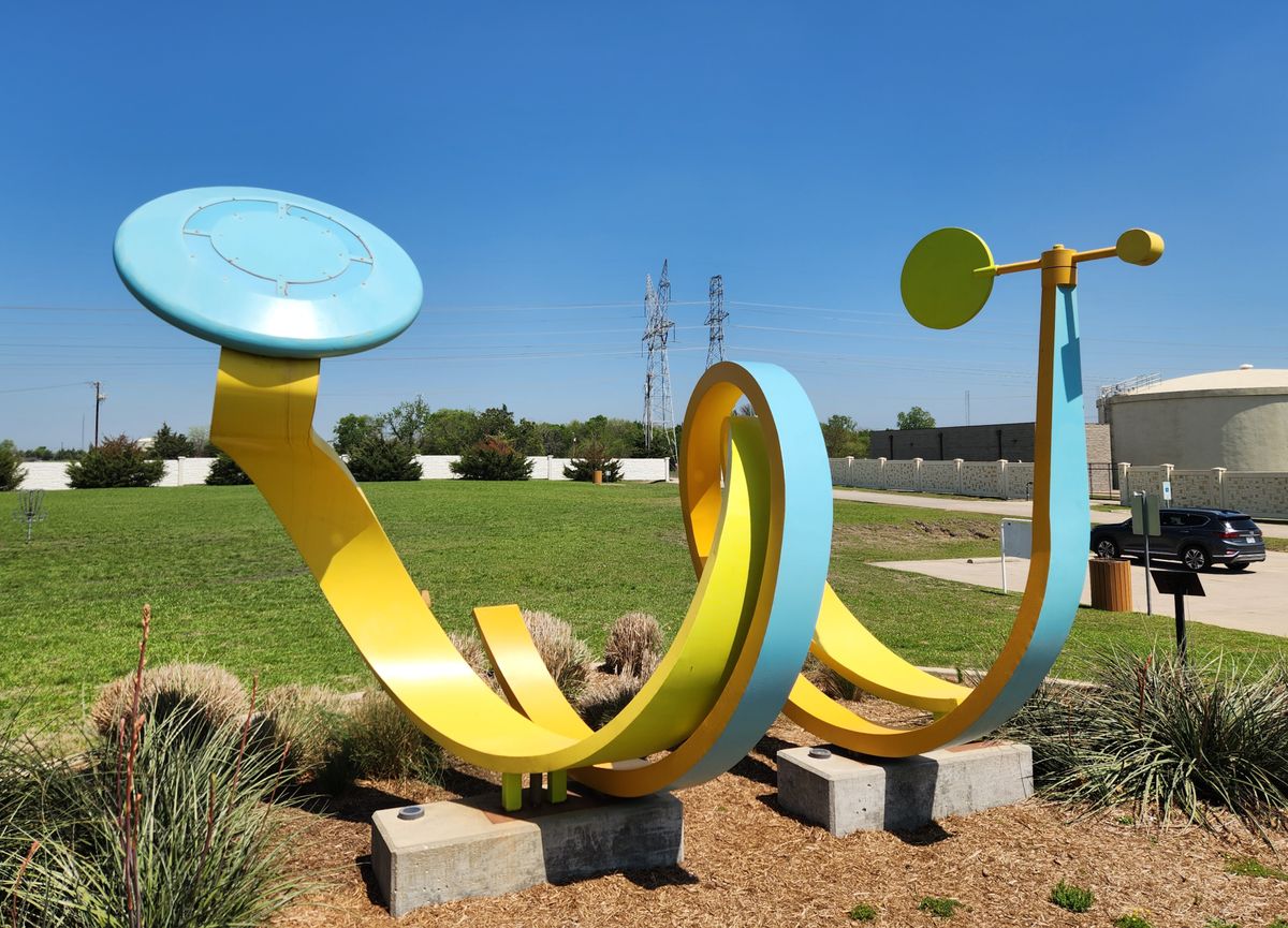 "Liftoff" disc golf inspired sculpture by John Davis, located near start of course.