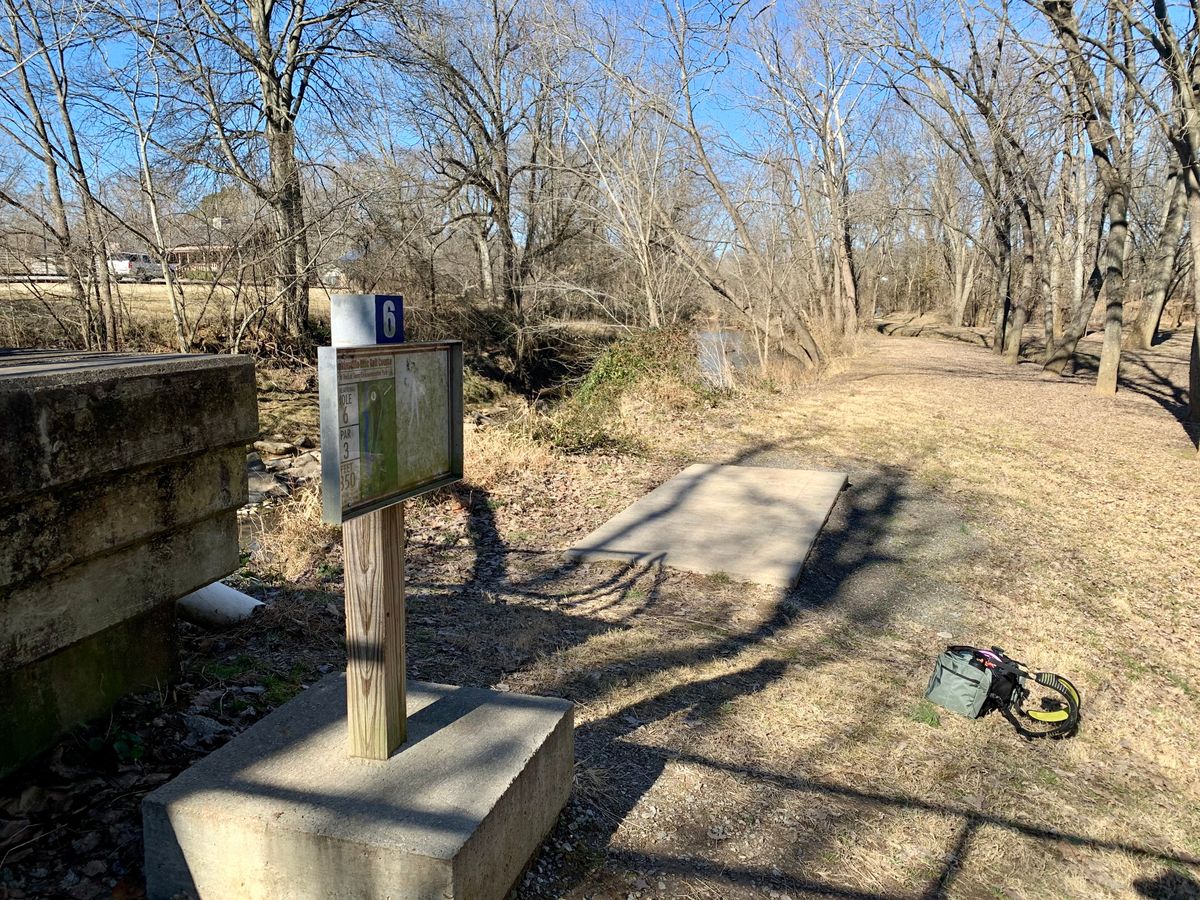 Tee pad for #6 through #9 across creek via bridge.