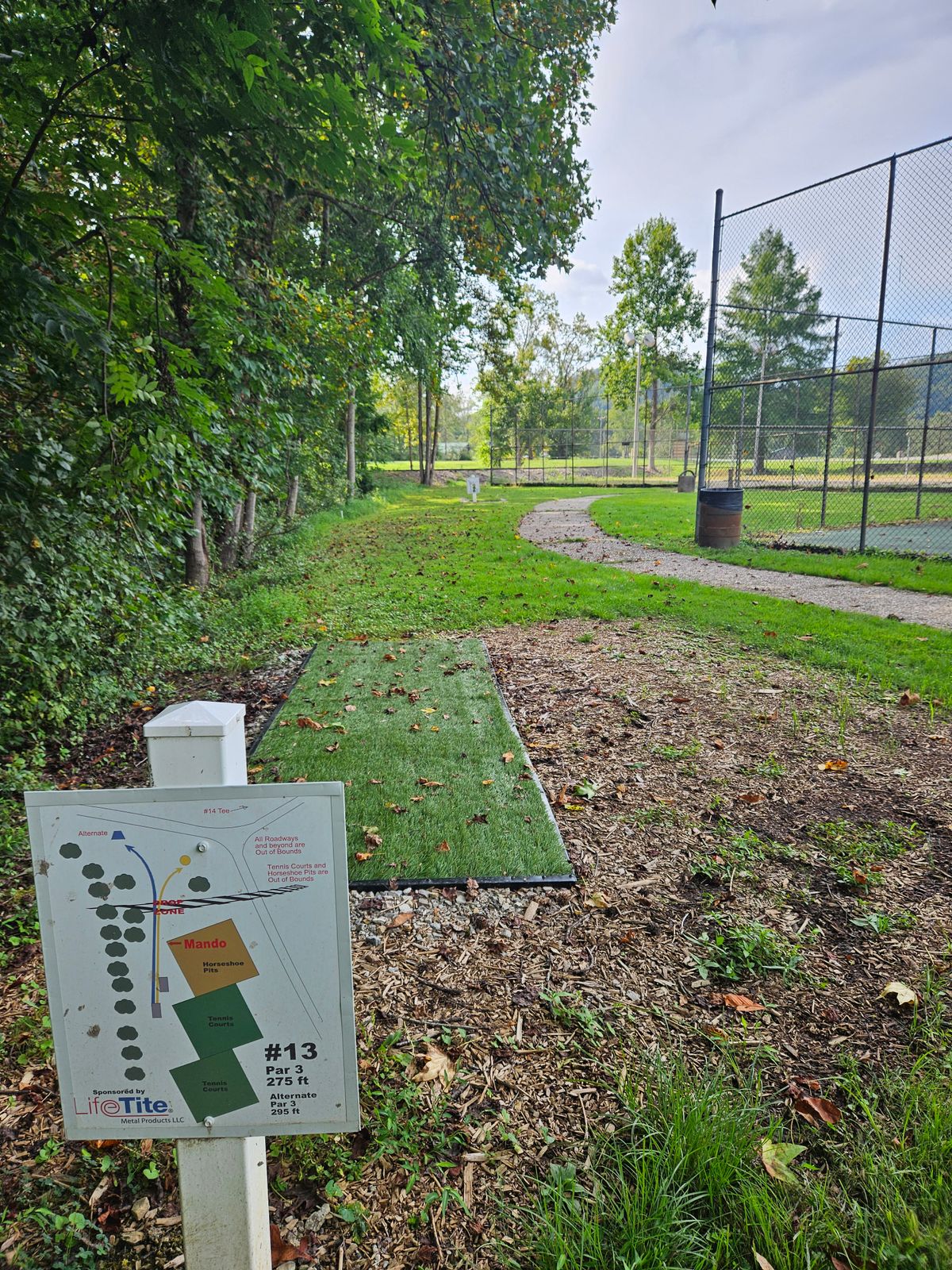 Hole 13 Long Teepad. Short Basket Right, Long Basket Left. Note: Mandatory Left of Fence Corner.  OB staked along Left side of fairway.