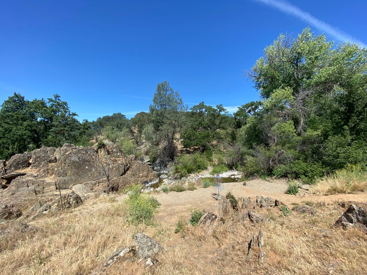 Downhill Green on Hole 6, small creek behind