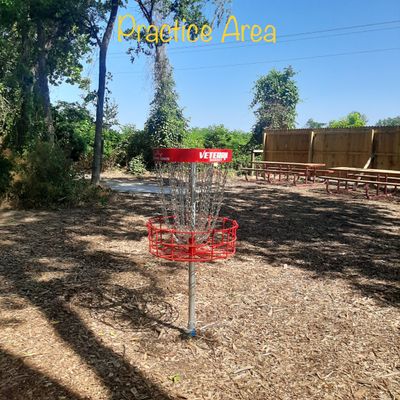 Practice putting area, benches & trash can.