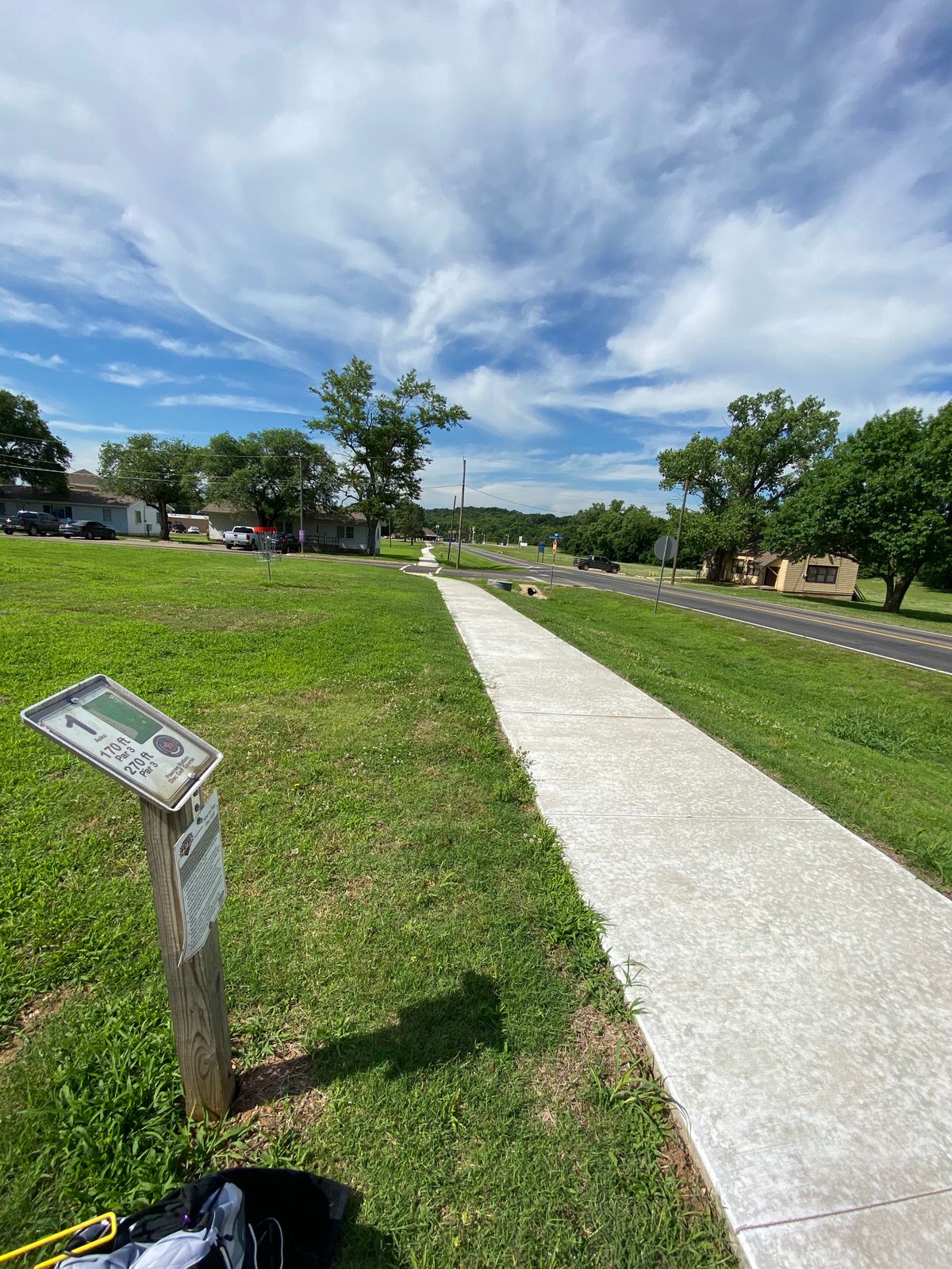 Park at the Community House, walk on the sidewalk towards the railroad track, hole 1 is on the right