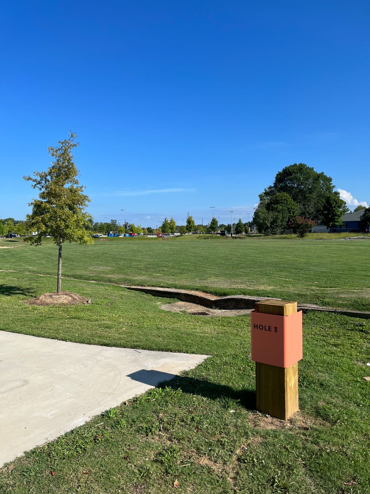 Hole 3: on or over sidewalk to the left. In the beach volleyball courts. In the parking lot.