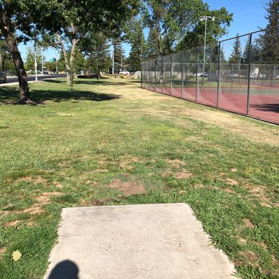 Hole 1 tee pad. Get the disc around the edge of the chain link fence.