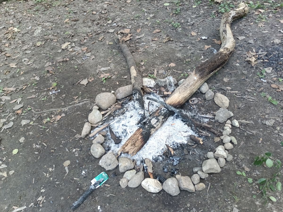 The tee for hole 2, someone built a fire pit.