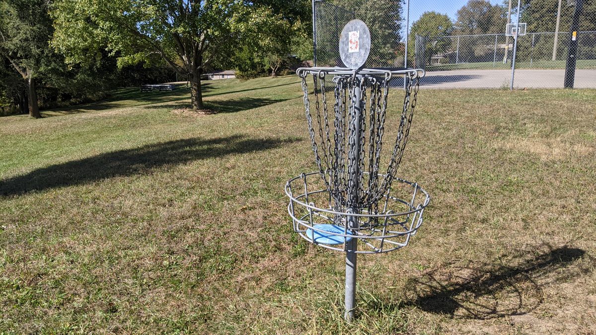 #9 Basket with #1 Tee beyond basketball court by pool house.