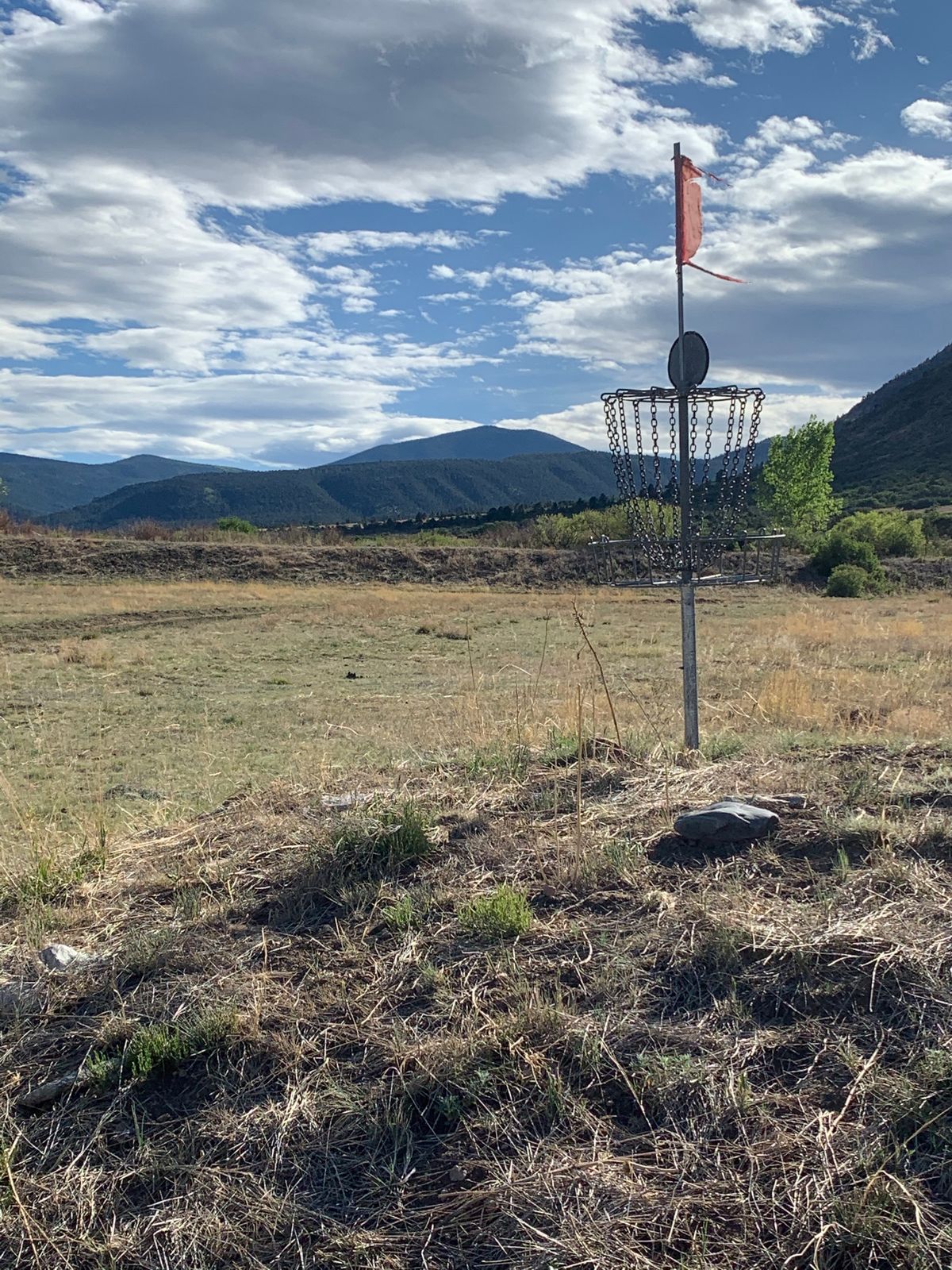 Hole 15 basket with Trail Peak in the background.