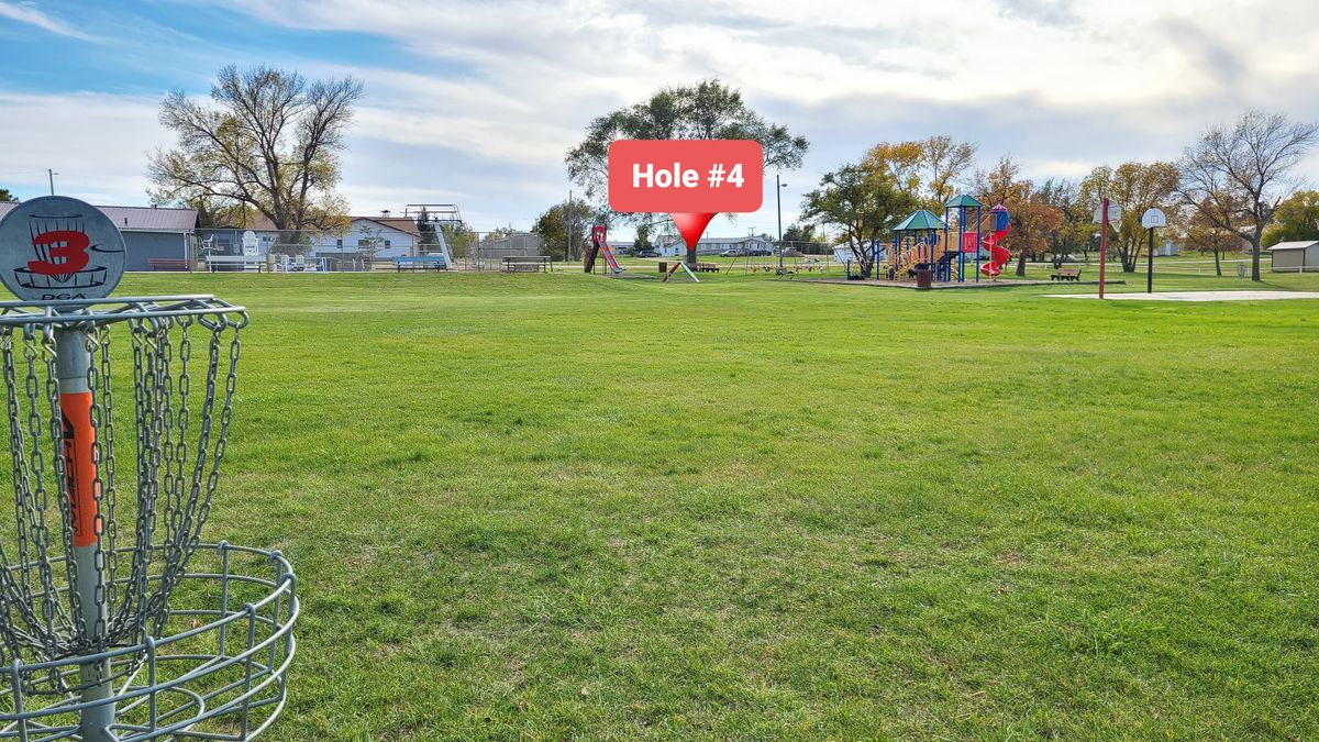 Hole 4, basket is over seesaws close to playground equipment.