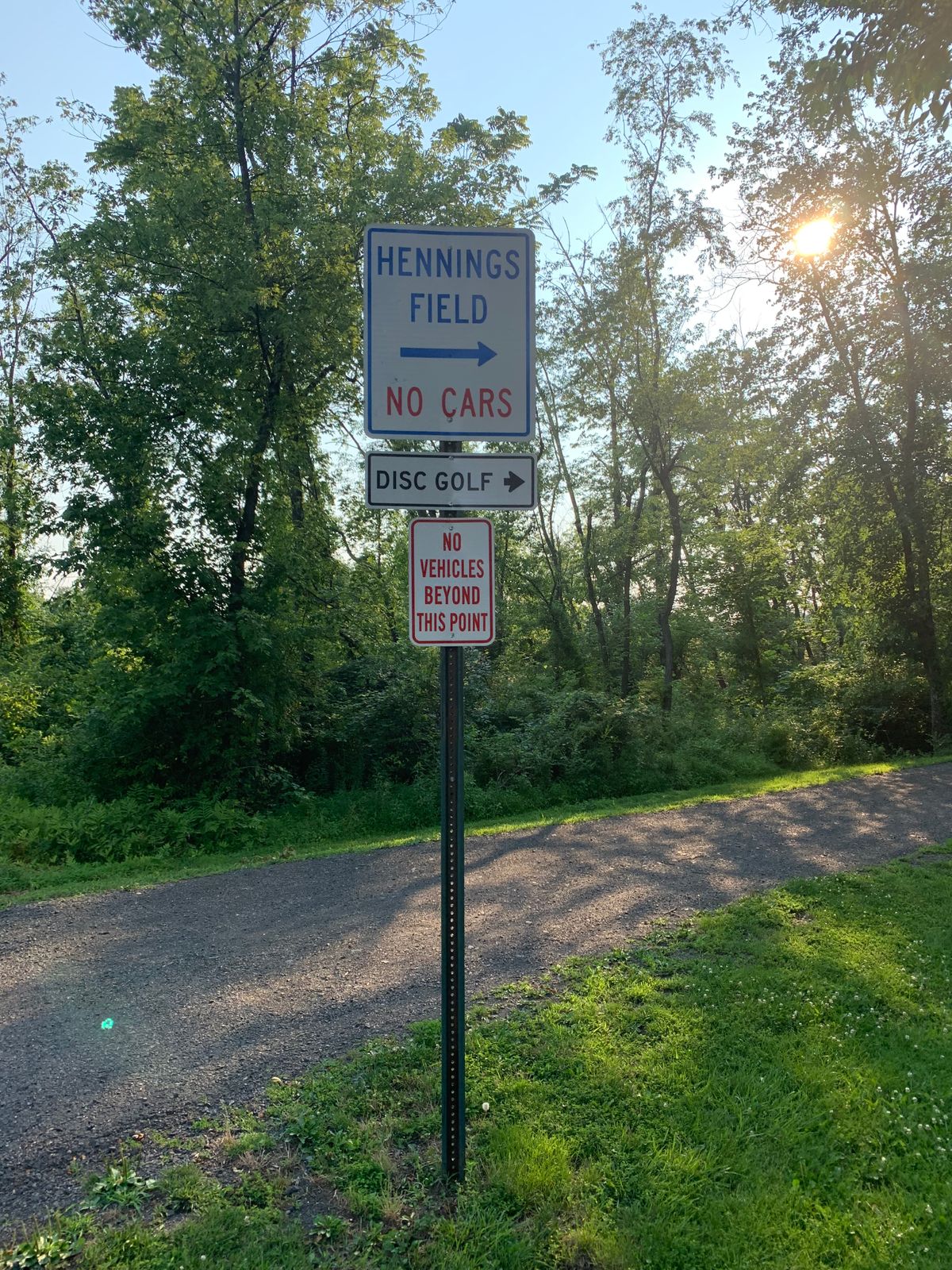Entrance on back end of parking lot. Enter, go over creek and turn left at the house to hole 1.