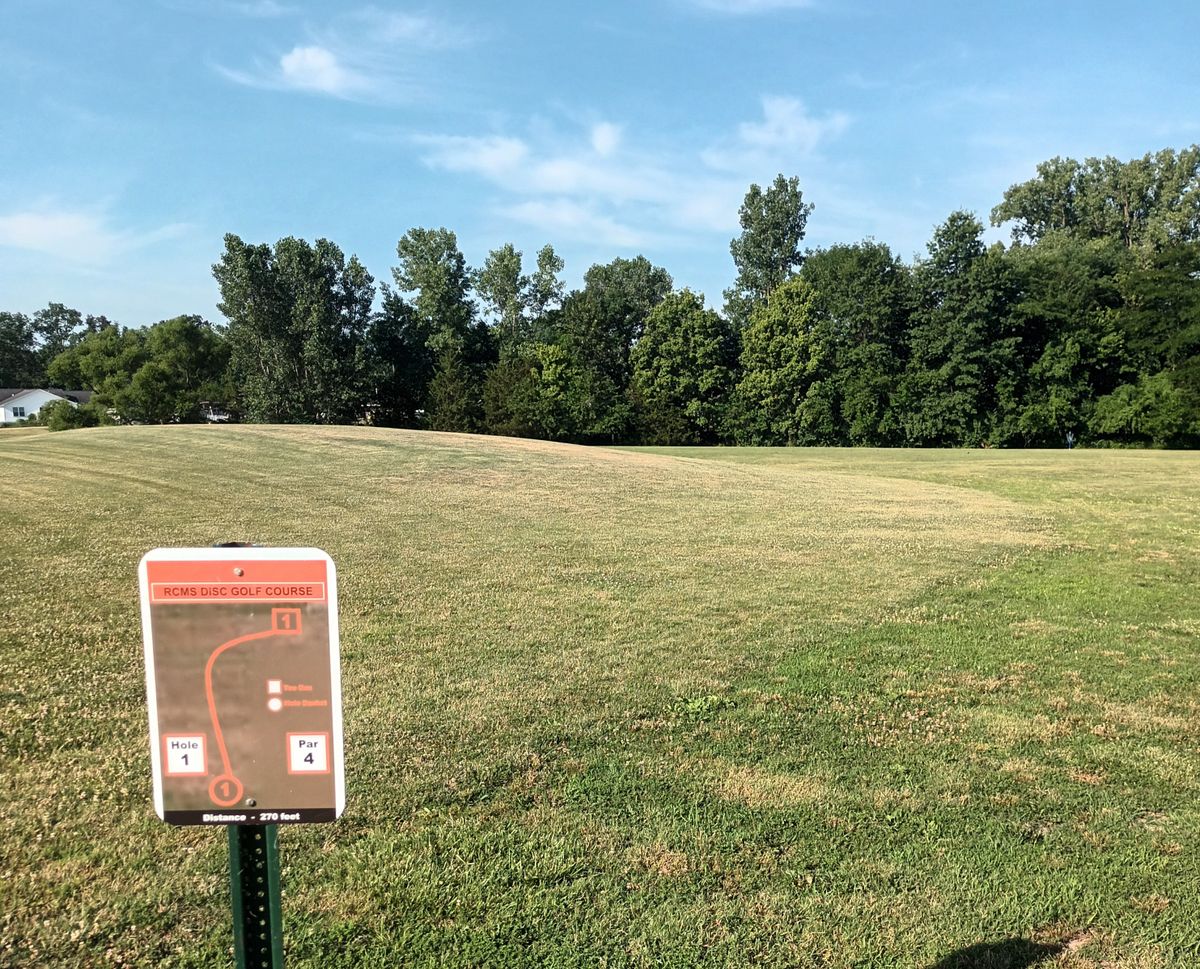 Hole 1. Basket on other side of hill just out of view