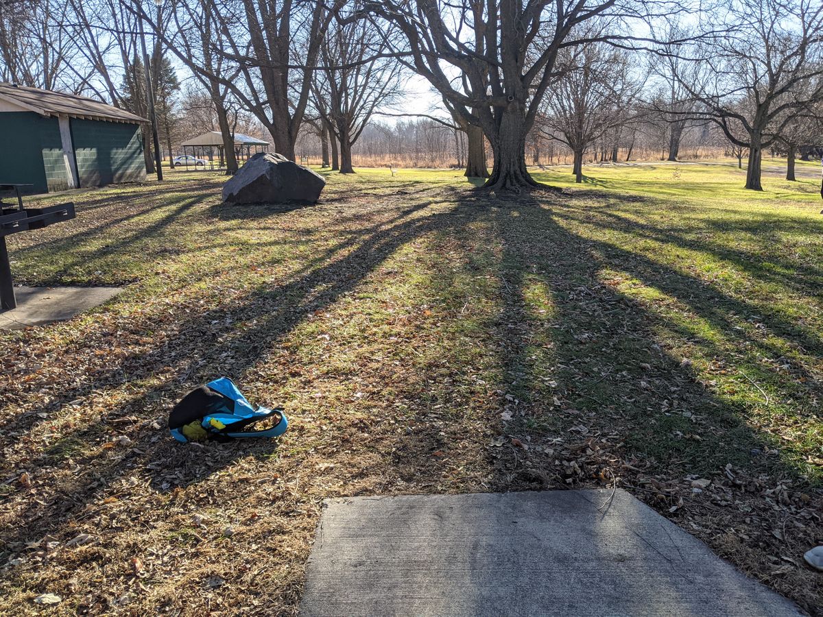 Could see the pin by looking thru small gap in two big trees on the middle.