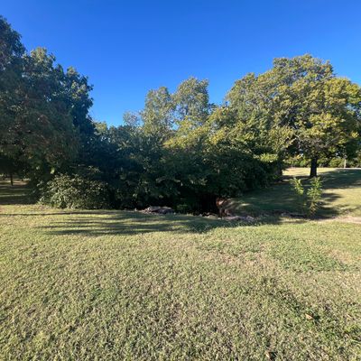 The tee off of hole 8 (left) over the creek twice, and into the basket (right, in between the trees)