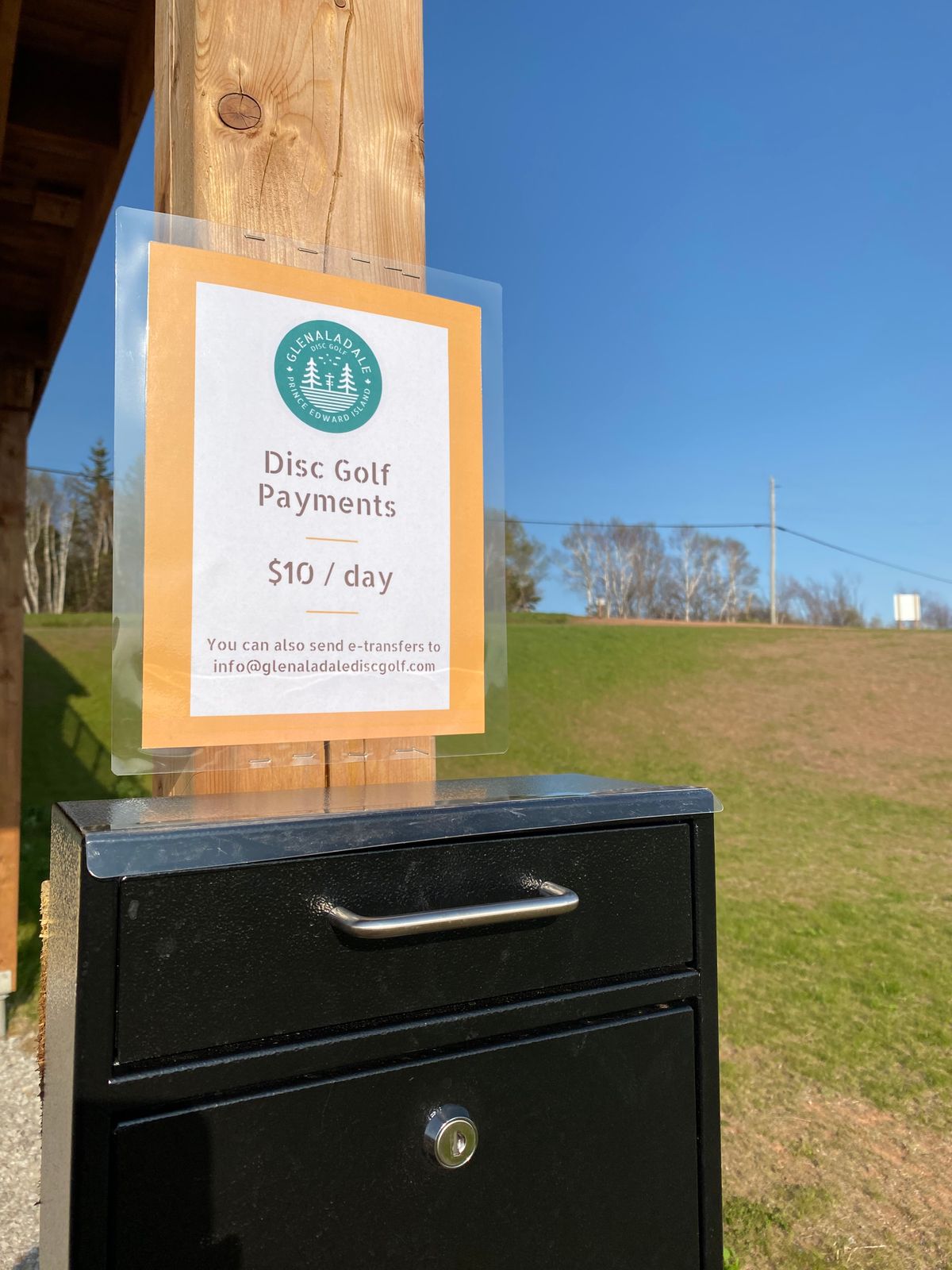 Payment box located near the practice basket by the parking lot. This is at the yellow schoolhouse.