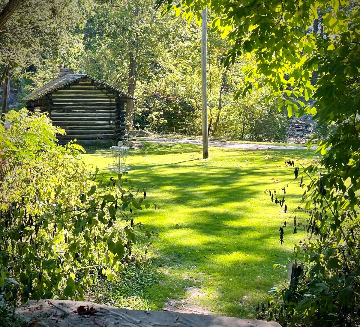 #4 with the log cabin in the background.