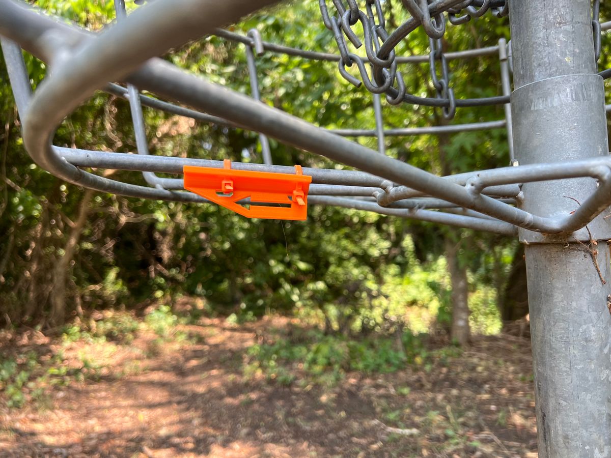 Directional arrows on the baskets for the next tee.