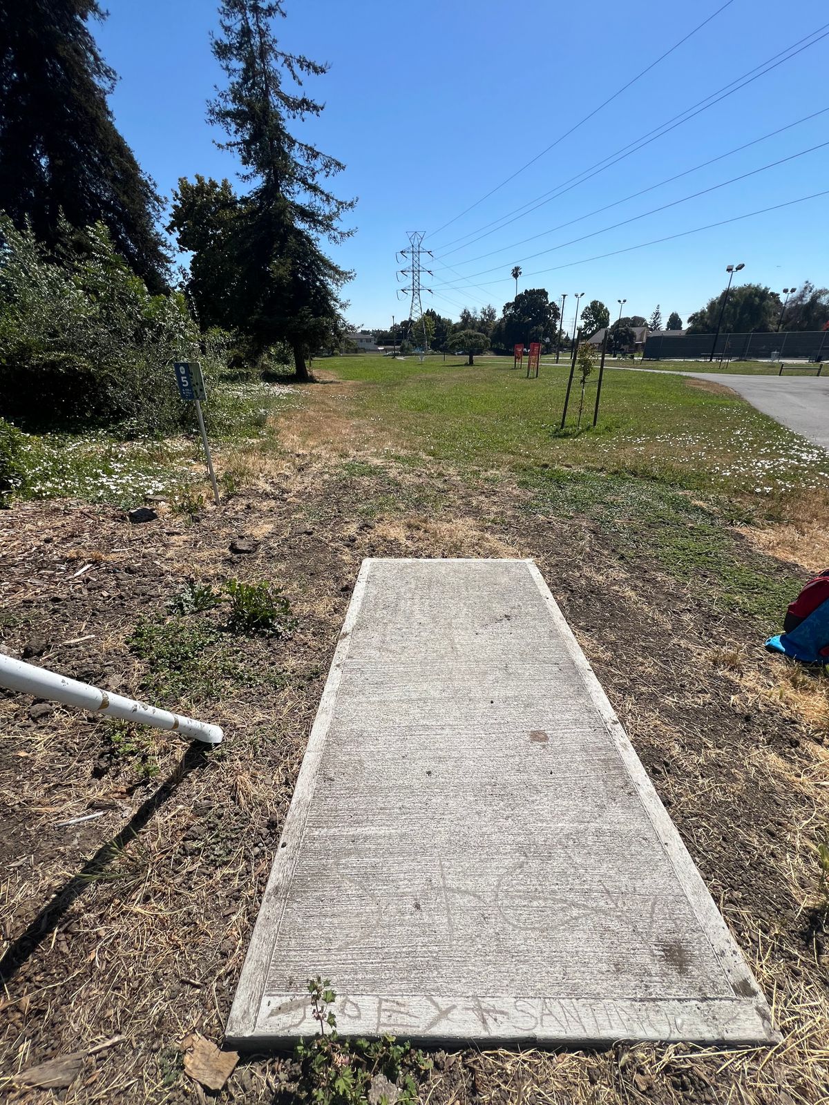 Hole 5 tee, right next to bench / side entryway