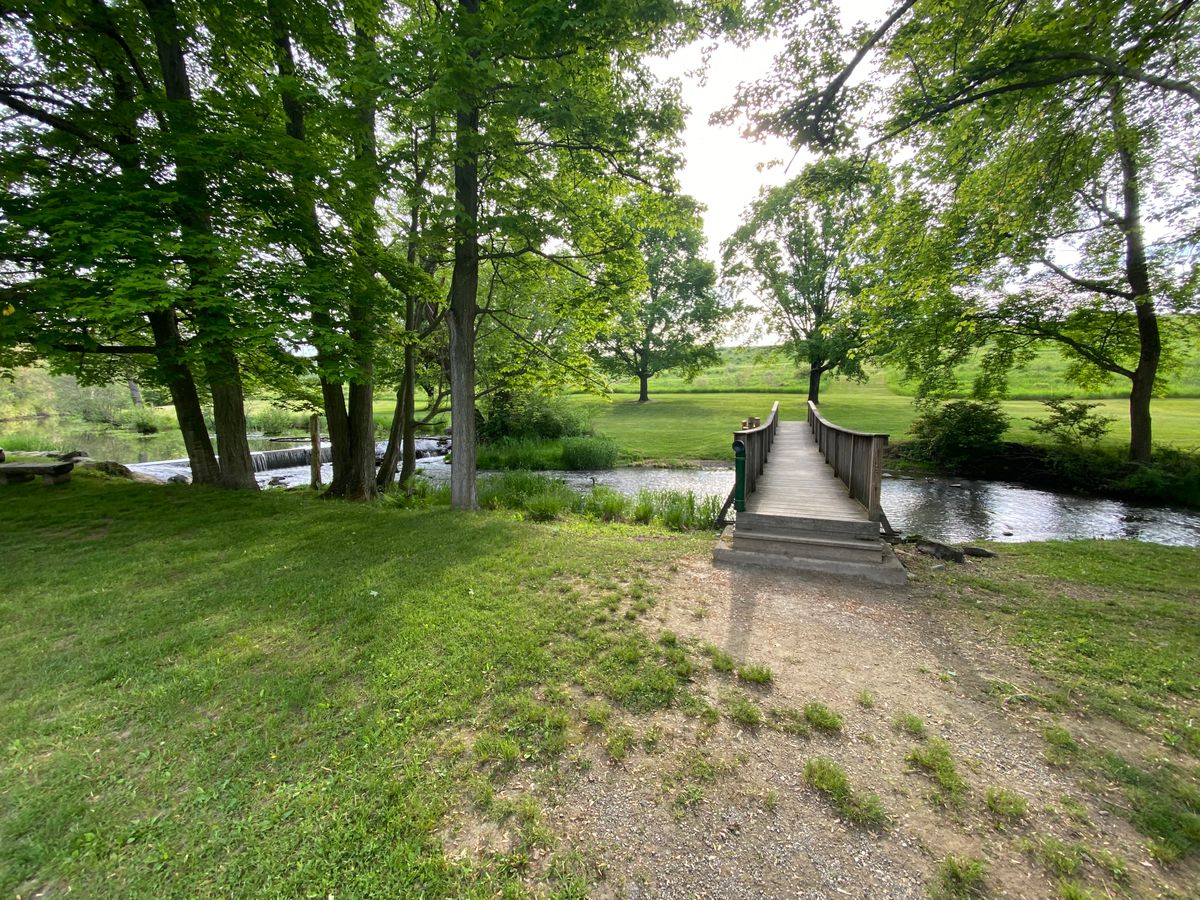 Cross the bridge, 1st tee is to the left. 