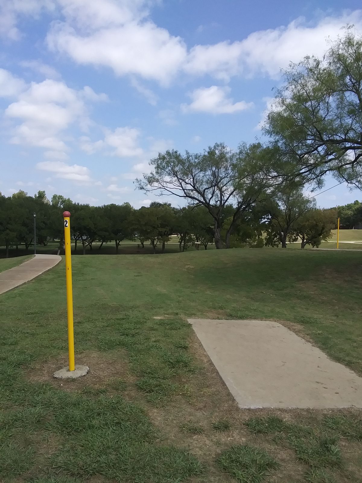 It's the basket down the hill in the middle of the trees. Not the one directly to the right.