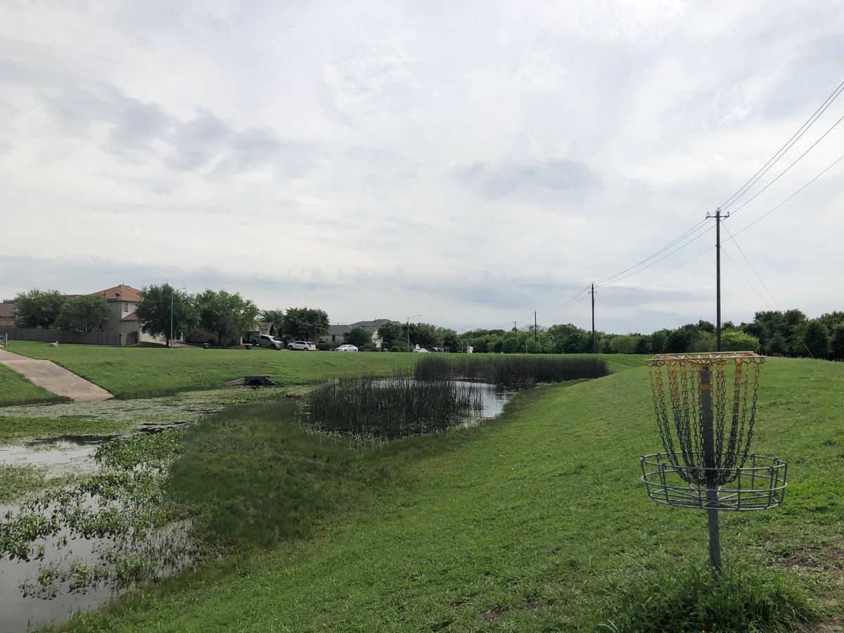 Basket 14, back to tee, about 330’. Obstacles are water and basket on ridge.