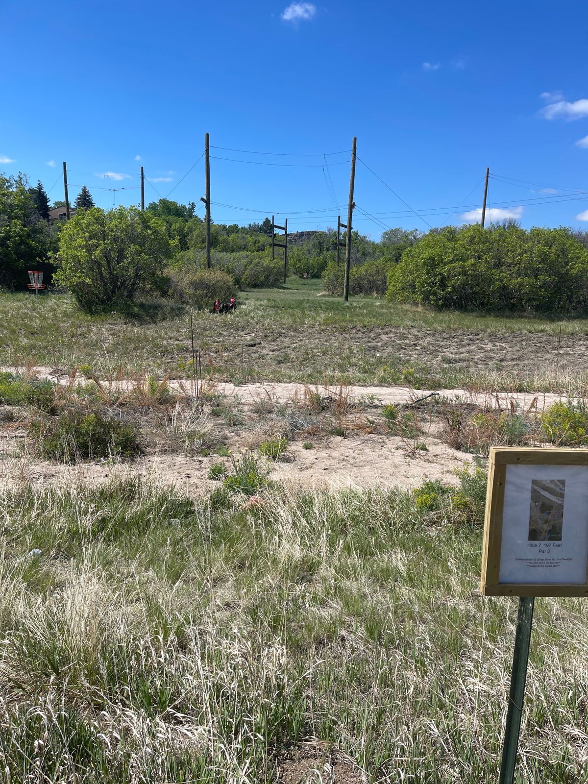 7 tee box with Castle Rock behind the basket.