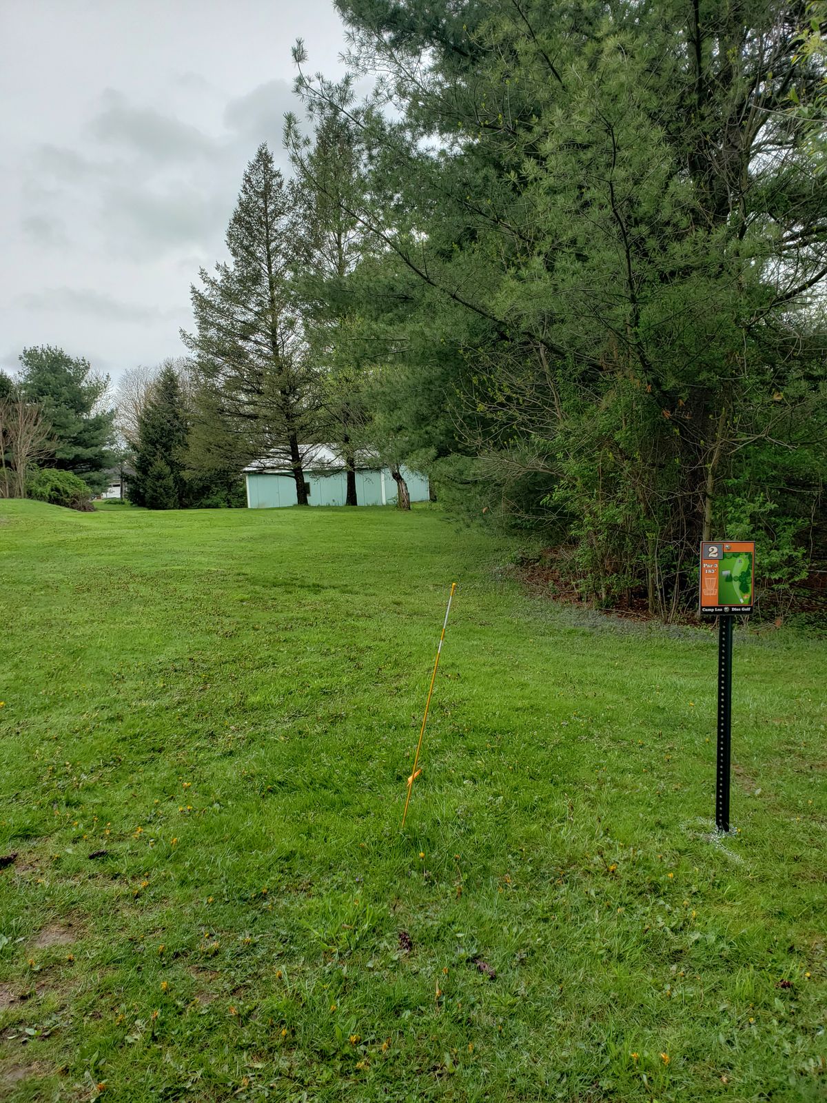 Basket for hole 2 is to the right of the storage building.