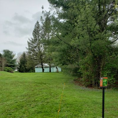 Basket for hole 2 is to the right of the storage building.