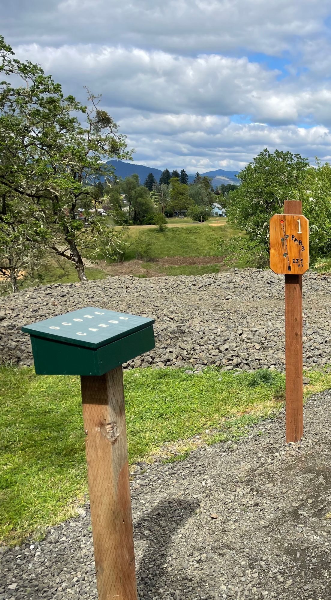 Scorecard box next to hole 1 tee pad.
