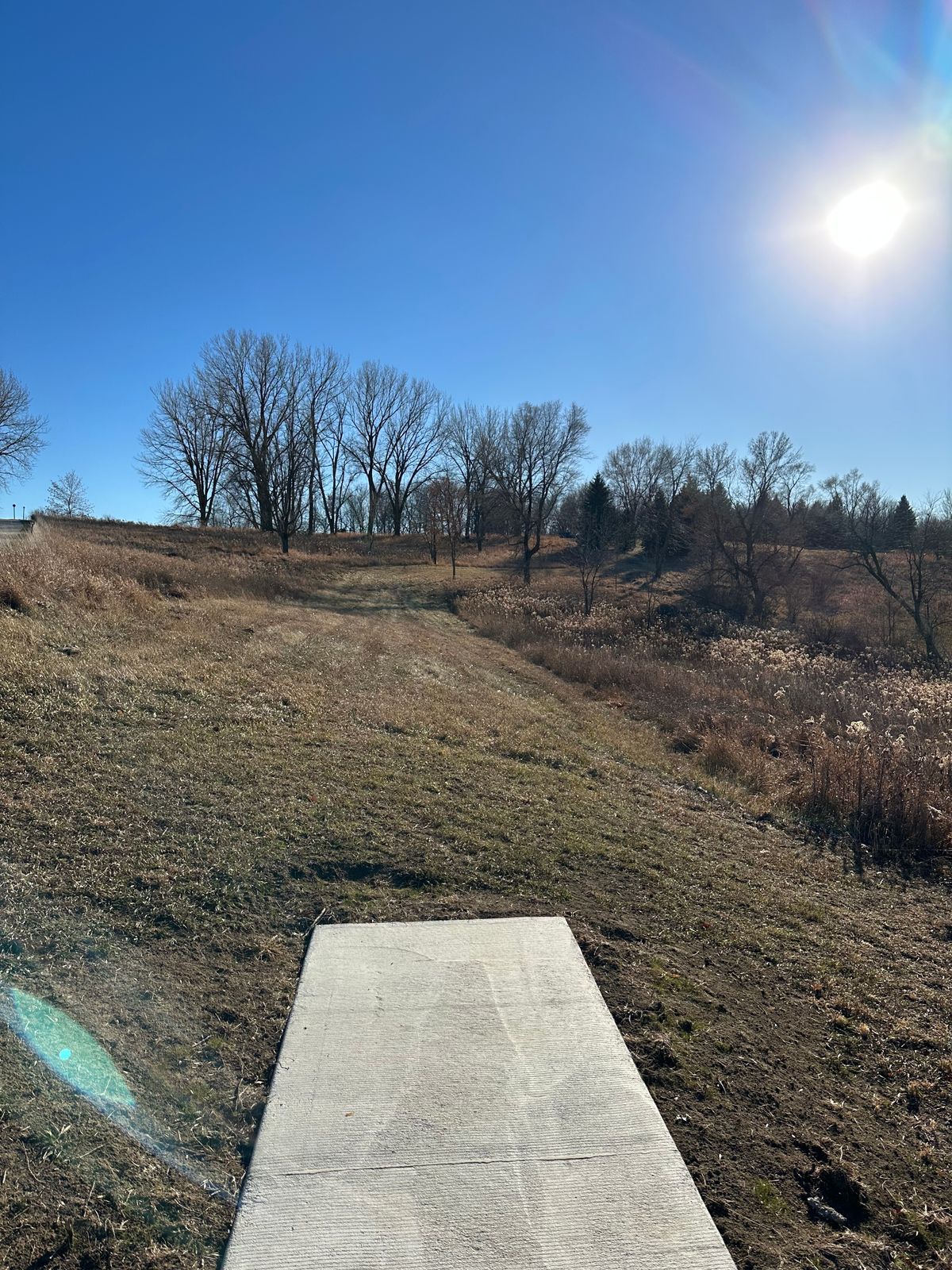 Hole 9 Teepad. The fairway has nearly a 90 degree break to the right about halfway to the basket.