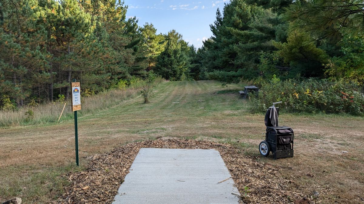 Tee of two. This hole plays down hill and to the left. There are numerous mature white pines guarding circle one and two. I am also convinced the guardian white pine has some form of plastic magnetism.