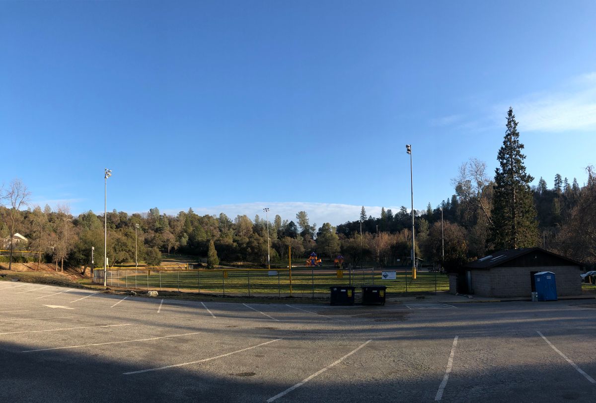 Course plays in hills behind field and playground