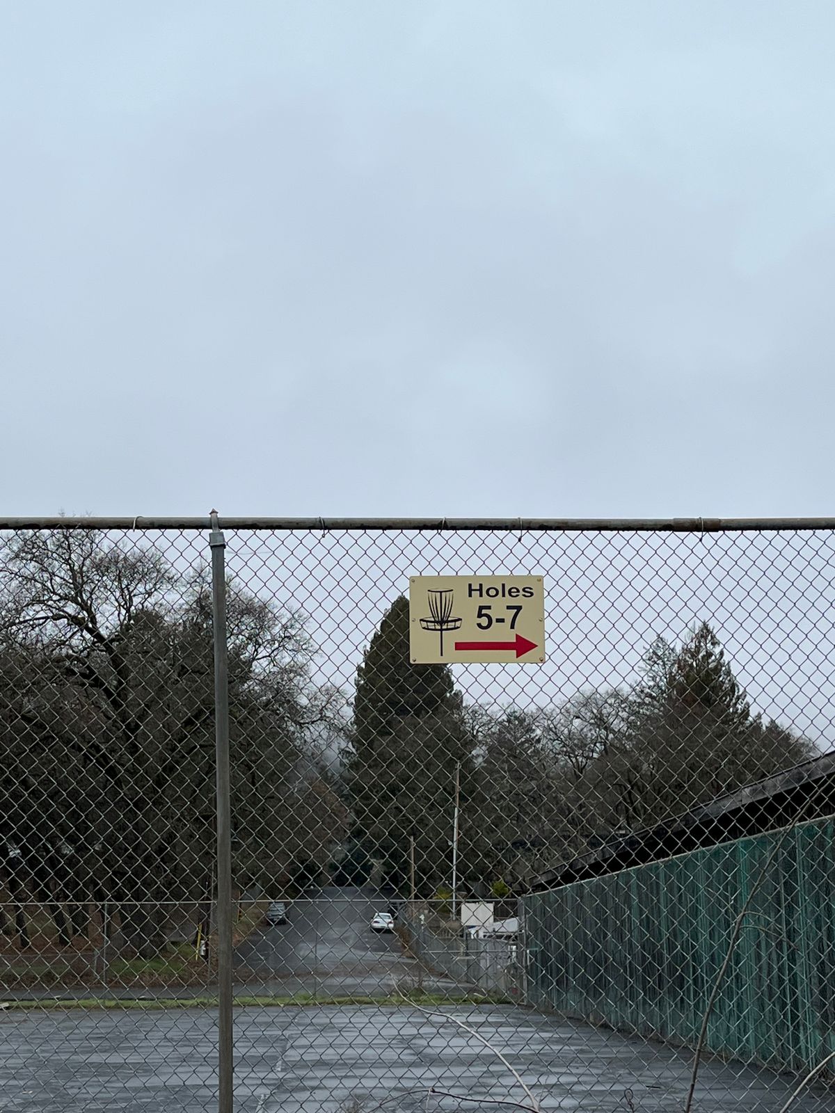 Signage pointing to holes at soccer field next door.