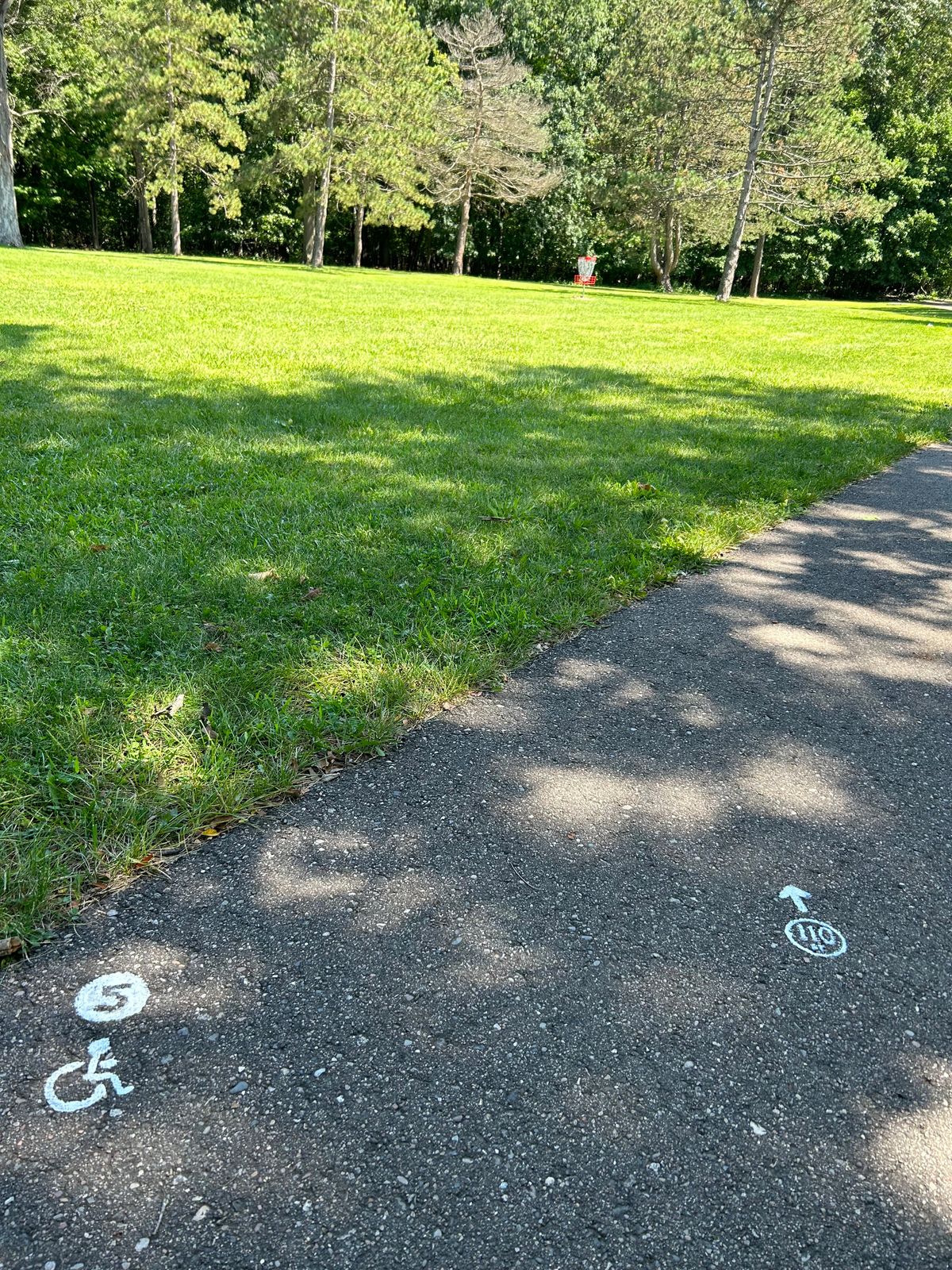 Wheel chair friendly tee 5 walking path past basketball court