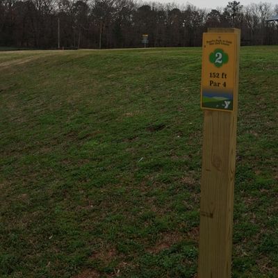 low, uphill tee to green that drops off behind basket