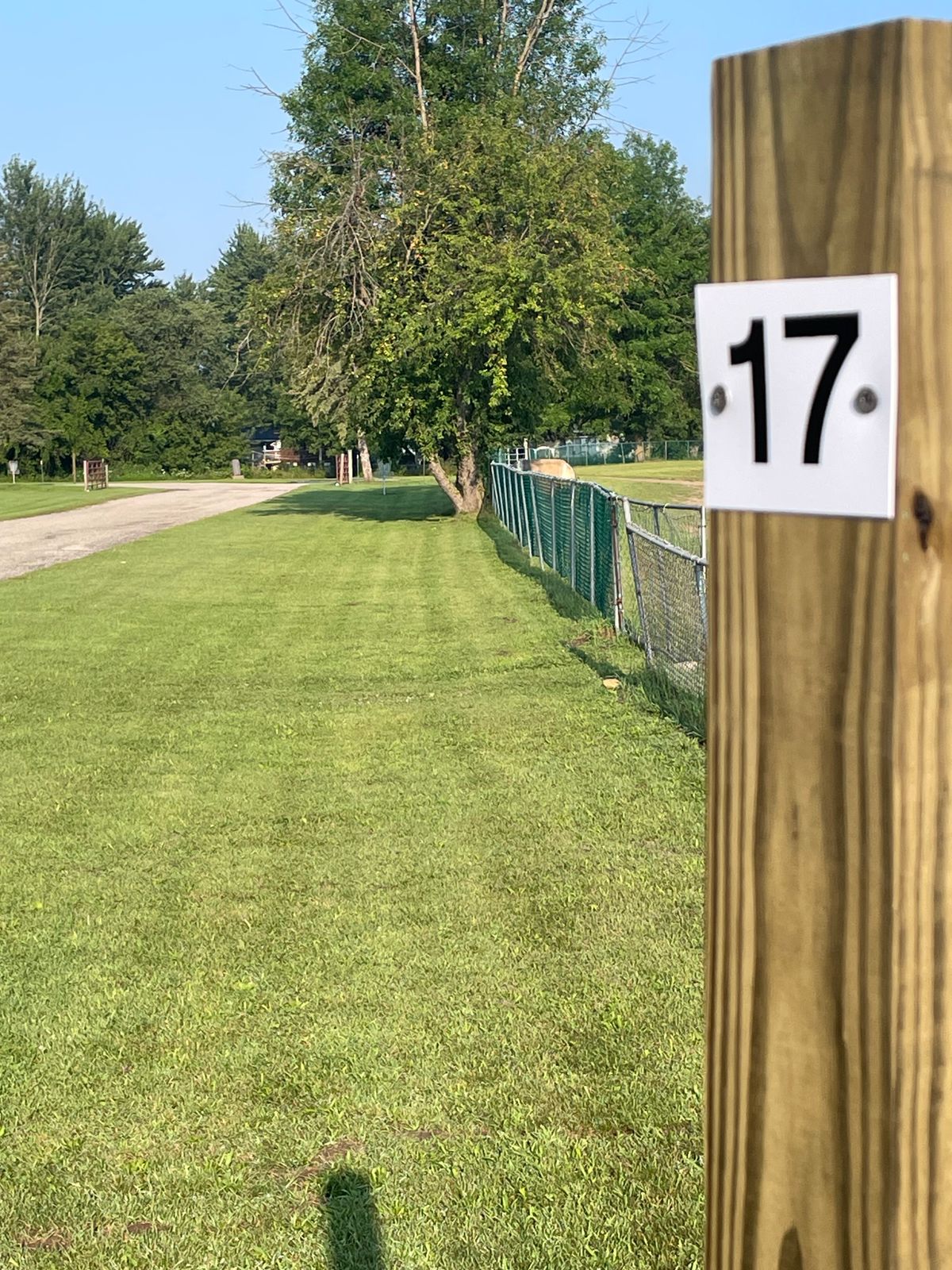 Hole 17 narrow fairway. Road left and over OB, fence right OB.