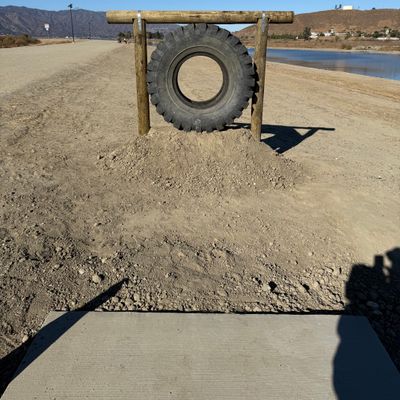HOLE 8 TEE PAD "THE TIRE" - MANDATORY THROUGH THE TIRE - RE-TEE TAKE A PENALTY EACH TIME MISSED