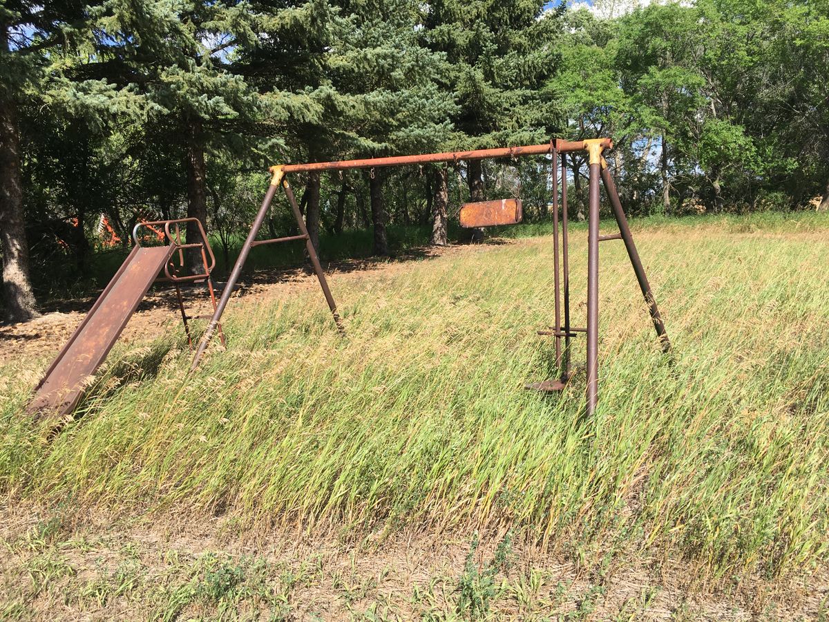 Next tee box is beside this old swing set, shoot over the trees.